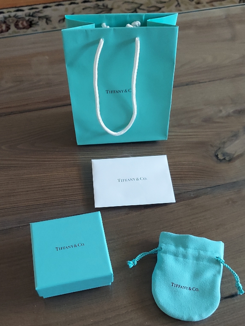 Tiffany & Co. Shopping Bag, Suede Jewelry Pouch, Blue Gift Box, and Envelope